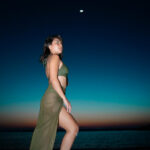 Night photo of Lex Arianne in water with moon glowing behind – Dubai beach photography"