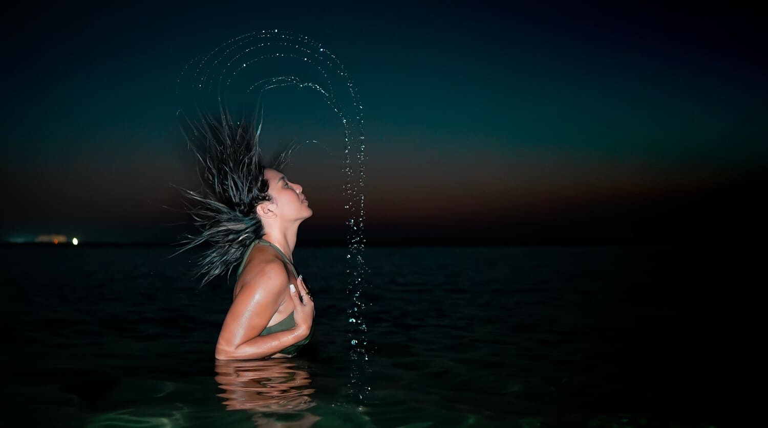 Lex Arianne 1 Night photo of Lex Arianne in water with moon glowing behind – Dubai beach photography"